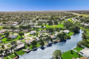 Aerial view of a suburban neighborhood with houses by a waterway.